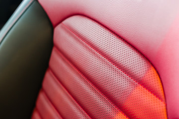 Red leather passenger seat in modern sport car, frontal view