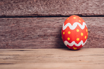 Beautiful Easter egg on wooden background