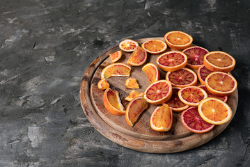 Sliced Blood oranges fruits over old dark wooden background