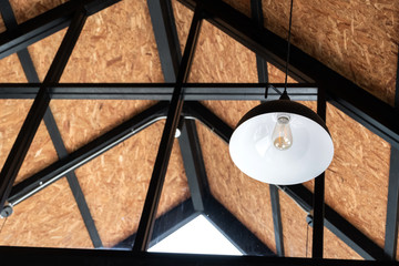 Modern loft house lighting design, lamp on ceiling, steel structure. Interior design concept.