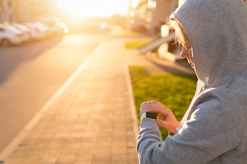 Woman athlete using smart watch activity tracker time and gps during running training.