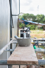 Paint cans and equipment on scaffolding for painting the wall in construction. Construction tool paint.