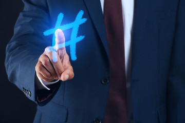 Businessman drawing hashtag symbol, closeup