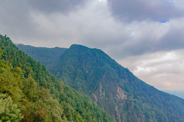 Mountain ridges under clouds and fog on top of Cangshan Mountains in Dali, Yunnan, China