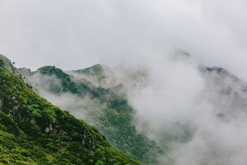 Mountain ridges covered by clouds and fog on top of Cangshan Mountains in Dali, Yunnan, China
