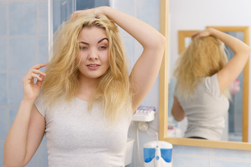 Woman feeling tired in bathroom