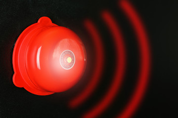 Modern alarm bell on wall indoors