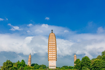 Three pagodas of Chongsheng Temple against Cangshan Mountains covered in clouds in Dali, Yunnan, China