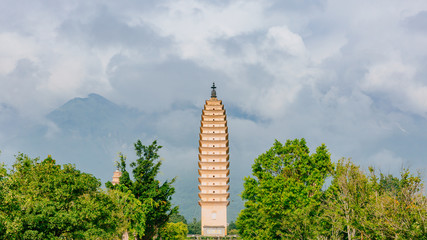 Three pagodas of Chongsheng Temple against Cangshan Mountains covered in clouds in Dali, Yunnan, China