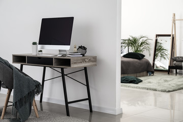 Modern workplace in stylish interior of studio apartment