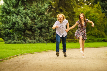 Naklejka na ściany i meble Happy couple playing in park