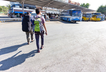 Young backpack travelers getting into bus. Local bus in Karnchanaburi province, Thailand.