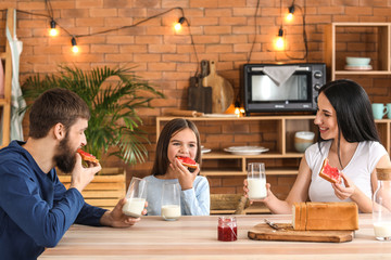 Happy family having breakfast at home