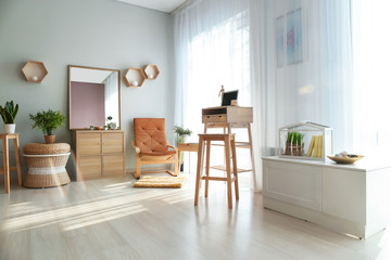 Stylish interior of room with wooden furniture