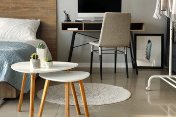 Interior of beautiful bedroom with comfortable workplace
