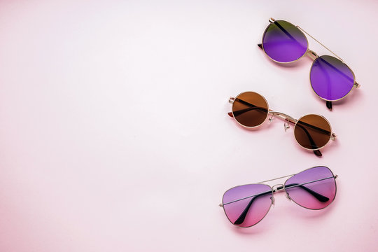 Different stylish sunglasses on color background
