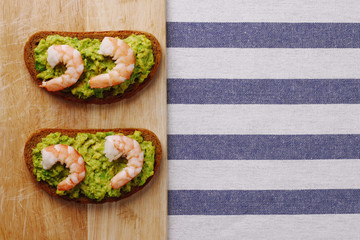 shrimp and avocado on bread with light background healthy breakfast