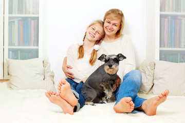 Mother with her 10 years old kid girl sitting home, casual lifestyle photo series. Cozy homely scene.