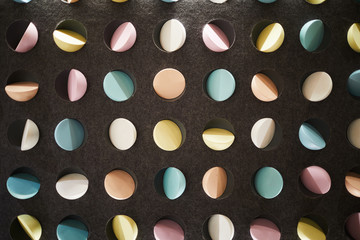 Black wall with many colorful elements inside contemporary cafe that can be used as background