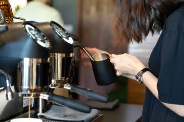 Barista use coffee grinder for make cappuccino.