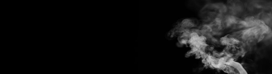 White smoke on a black background. Texture of smoke. Clubs of white smoke on a dark background for an overlay