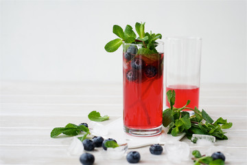 Berry lemonade in glass cups on light background. Close up view