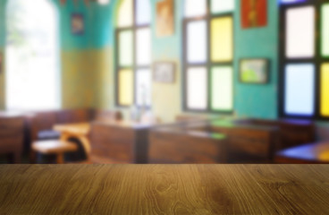 Empty wooden table in front of abstract blurred background of restaurant, cafe and coffee shop interior. can be used for display or montage your products - Image.