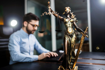 scales of justice against the background of a lawyer, a judge of the prosecutor. concept of...