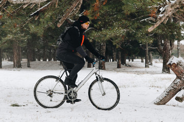 Man on a bike in the winter forest