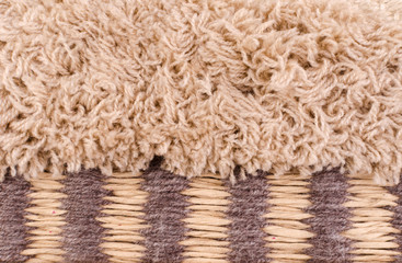 Horizontal fragment of tapestry with wool threads. Colorful fabric with fluffy texture in warm colors. Multi colored background with close up of a traditional beautiful textile. Craft carpet texture.