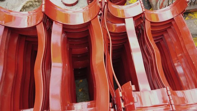 Red casing centralizers stacked on the deck of a drilling rig