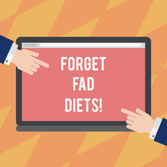 Text sign showing Forget Fad Diets. Conceptual photo drop pounds due unhealthy calorie reduction or water loss Hu analysis Hands from Both Sides Pointing on a Blank Color Tablet Screen