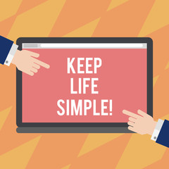 Text sign showing Keep Life Simple. Conceptual photo invitation anyone not complexing things or matters Hu analysis Hands from Both Sides Pointing on a Blank Color Tablet Screen