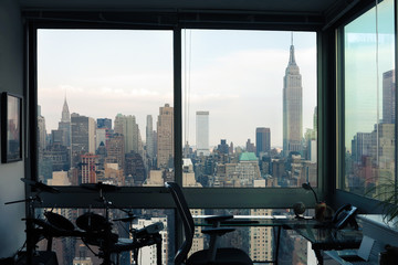 Fototapeta na wymiar View of skyscrapers of New York City (Manhattan) through windows of apartment. Top view of midtown of Manhattan. USA