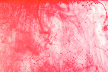 Red ink acrylic dropping in water, abstract background