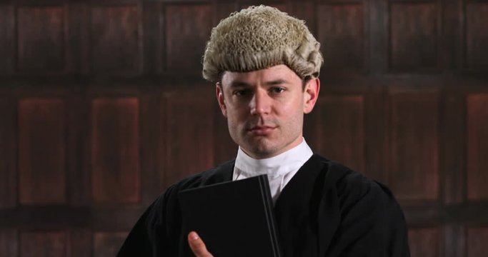 Portrait Of Male Lawyer In Court Reading Law Book