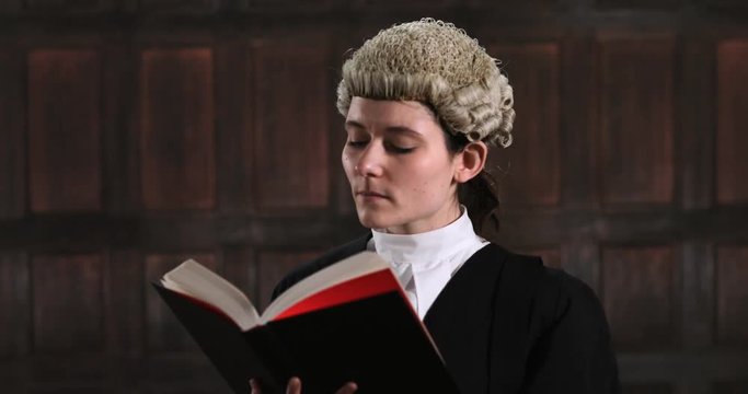 Portrait Of Female Lawyer In Court Reading Law Book