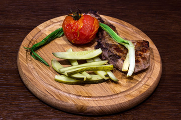 brisket with vegetables on a wooden board