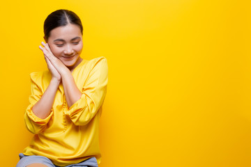 Woman feel shy standing isolated over yellow background