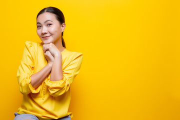 Woman feel shy standing isolated over yellow background