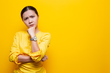 Woman feel confused isolated over yellow background