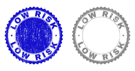 Grunge LOW RISK stamp seals isolated on a white background. Rosette seals with grunge texture in blue and gray colors. Vector rubber stamp imprint of LOW RISK tag inside round rosette.