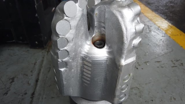 Gimbal Shot of New PDC Bit (Polycrystalline Diamond Compact Bit) on the floor for Oil and Gas Well Drilling