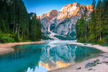 Spectacular misty lake with snowy mountains in Dolomites, Italy, Europe