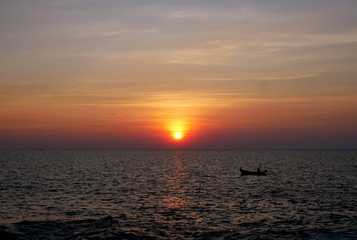 Sunset and small boats in the sea