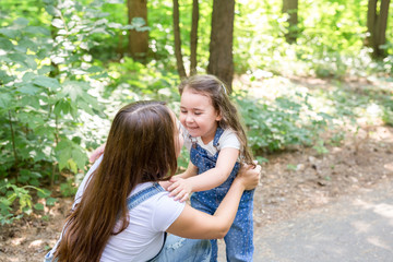 Family and nature concept - Portrait of mother and child playing in the park