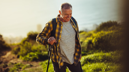 Senior man on a hiking trip - Powered by Adobe