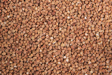 Buckwheat. Top view. Food Background. A scattering of buckweat grains. Healthy food. Natural food.