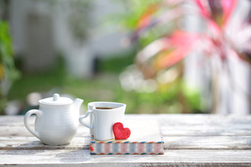 White kettle and cup with notebooks and red heart