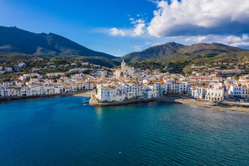 Fototapeta na wymiar amazing aerial panoramic view photo of Cadaques small cizy city by the sea in Spain. Sunny day and big clouds. Mountains. Nature